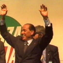 Silvio Berlusconi sorride con le mani in aria